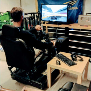 Photo of me playing Asseto Corsa on a racing simulator
